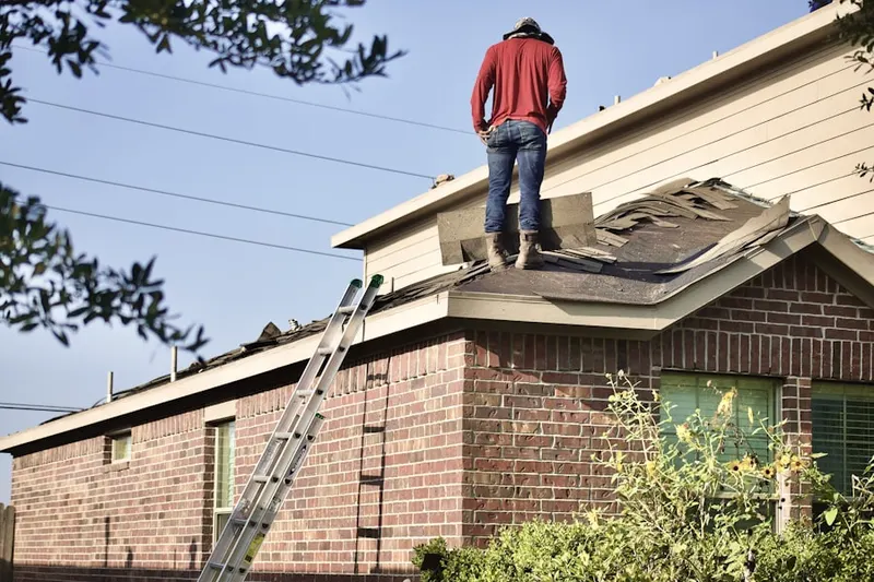 Professional roofer working on a residential roof in Fruitland Acres